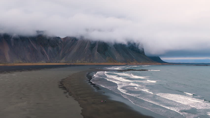 Vestrahorn coastal landscape with mossy rocks Vestrahorn. Hidden Icelandic shore with mist and volcanic formations
