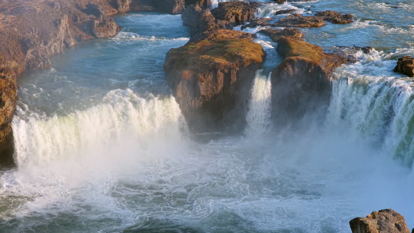 Aerial view of Powerful waterfall Godafoss pouring into a rocky basin. Iceland