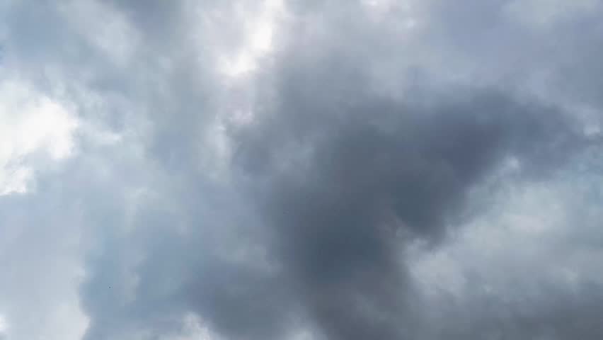 Heavy gray storm clouds fill the sky before rainfall, creating a dramatic natural weather background with an overcast atmosphere  