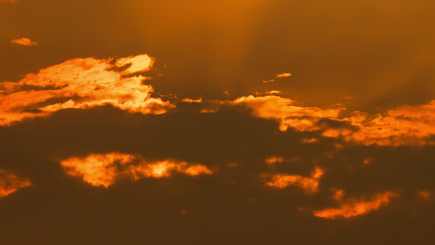 Peaceful sunrise time-lapse with warm golden light and fast-moving clouds.