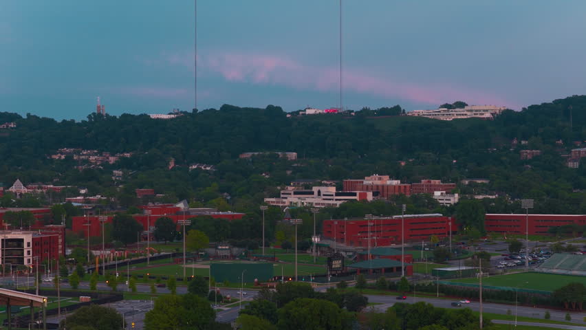 Dusk aerial of the UAB campus with baseball field, medical buildings and Red Mountain broadcast towers beyond.