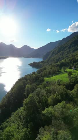 Aerial Lake Walen Walensee Switzerland sunset sunrise over Churfirsten mountain, vertical video