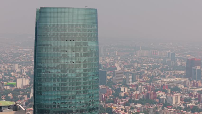 Drone panorama featuring a prominent tower in hazy daylight