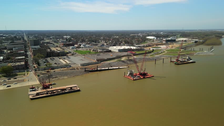 Downtown district borders a wide river with docks and city buildings