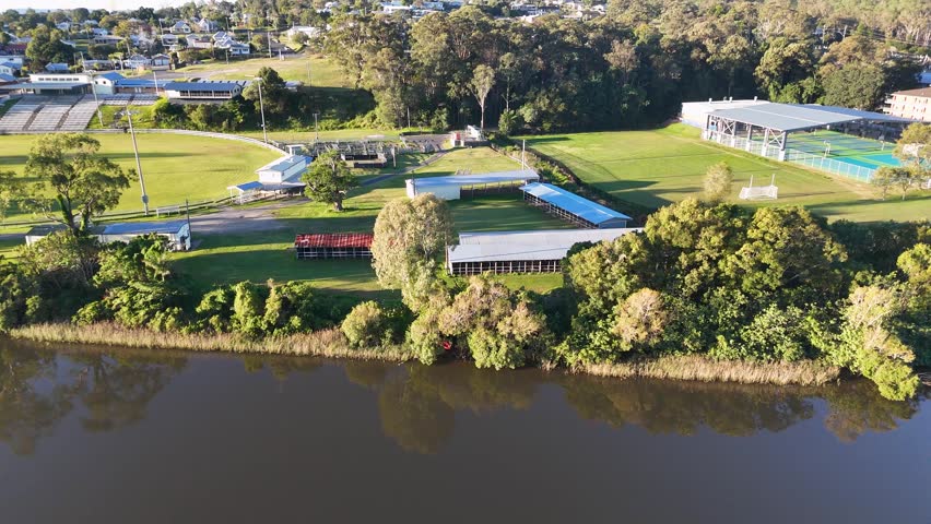 High-angle drone shot of a riverside sports complex and showground in Maclean, New South Wales.
