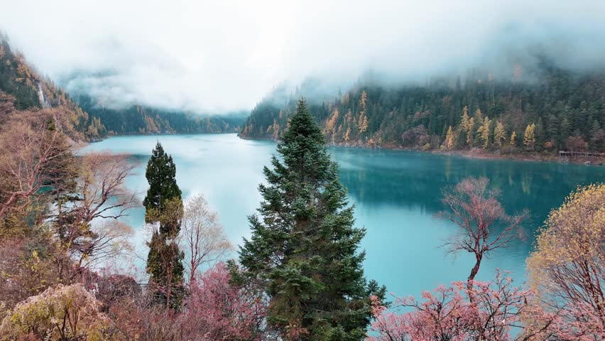 Scenery Jiuzhaigou national park in Sichuan, China. Beautiful Long lake and snow mountain in Autumn season. Famous Landmark and Vacation near Chengdu, China. Asia travel concept