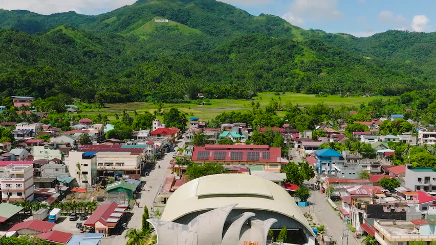 City with modern buildings and residential area in mountainside. San Agustin, Romblon. Philippines.