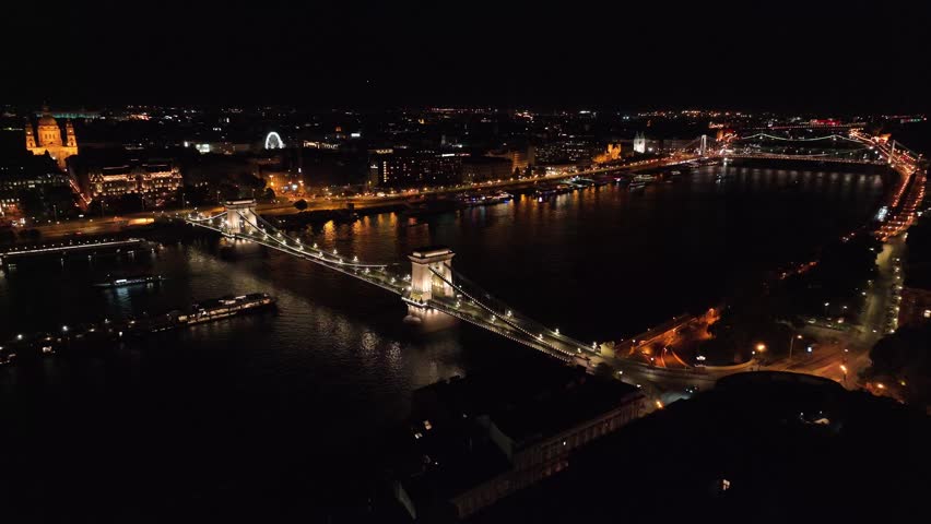 Flying over river Danube in Budapest at night. Széchenyi Chain Bridge seen on the first plan. I flew there in September 2025.