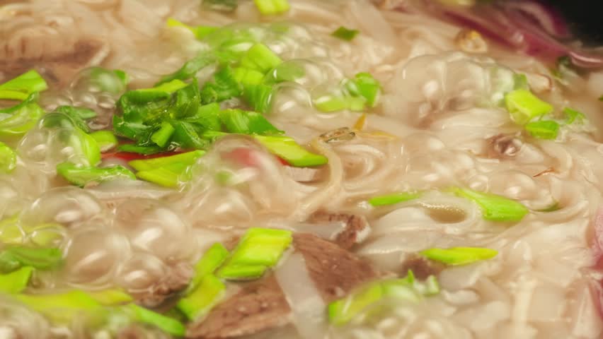 Vietnam traditional pho bo soup on delivery, Beef noodles. Pho Bo Soup with beef, rice noodles, ginger, lime, chili pepper in bowl. Vietnamese cuisine. Pho Noodle Soup restaurant Close-up.