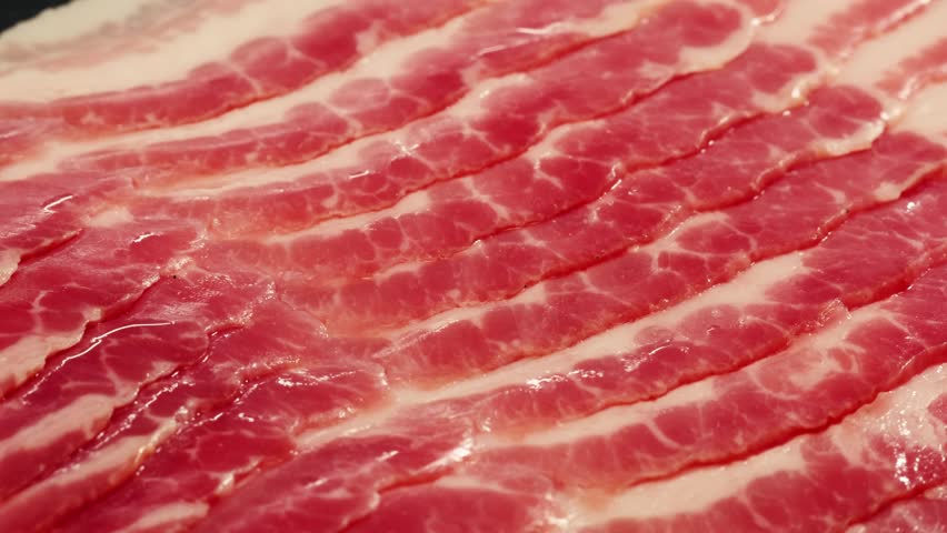  Sliced ham jamon fat bacon meat, beef pastrami thick pieces on a wooden board, beef or pork jamon. Chef cooking breakfast, smoked bacon in cafe. 