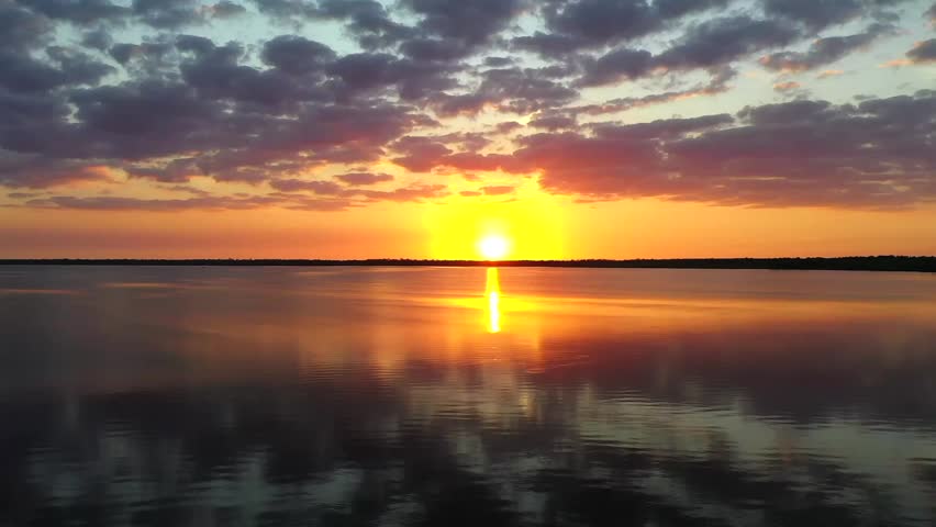 Aerial film over a lagoon at sunset