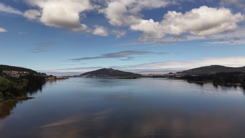 Rio miño river emptying into the atlantic ocean, forming an estuary separating spain and portugal