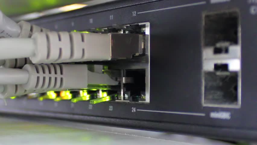 Modern network switch with cables and connectors. Led light shows activity.