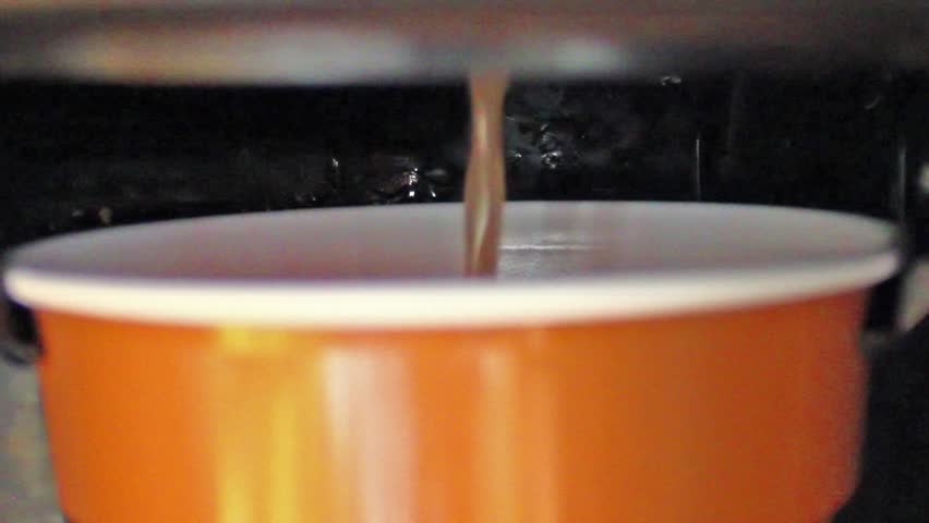 Automated machine - filling cup with hot fresh coffee, tea, macro