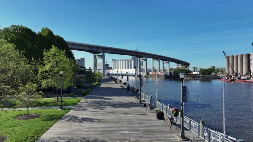 Aerial view of The Boardwalk at Canalside featuring wooden walkways, waterfront views, and the Skyway bridge in Buffalo, New York, United States.