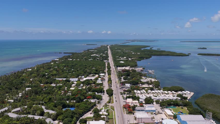 Aerial view of the Overseas Highway stretching through the lush tropical landscape of the Florida Keys in Islamorada, Florida, United States.