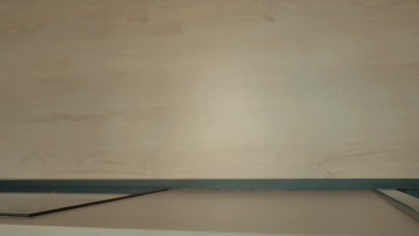 A hand placed a clear jug of water on the table.