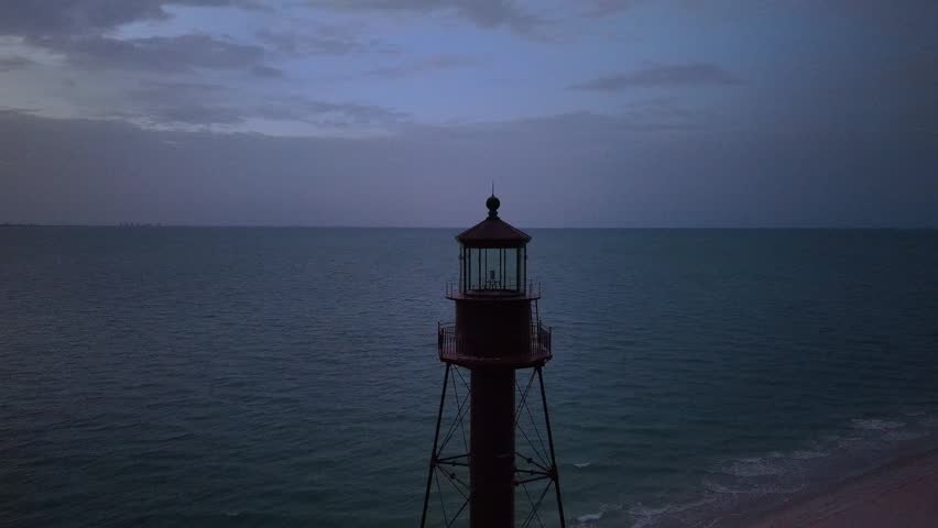 Aerial view of Sanibel Island Lighthouse at dusk with the ocean and sandy beach in Lee County, Florida, United States.