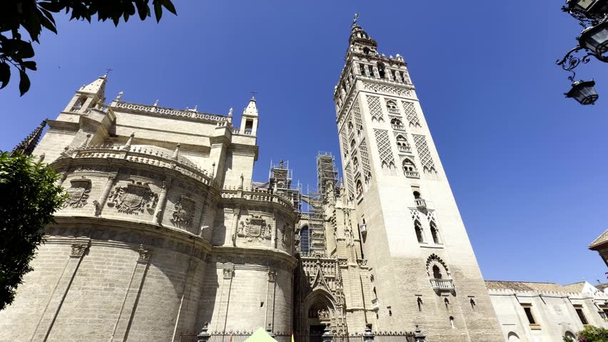 Low-angle view of the historic Seville Cathedral and La Giralda tower in Andalusia, Spain