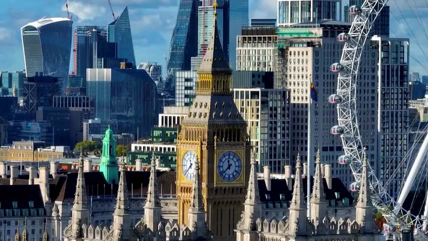 High-quality aerial drone shot of the Elizabeth Tower (Big Ben) in London, UK, showcasing the majestic Gothic Revival architecture and clock face under a clear blue sky 