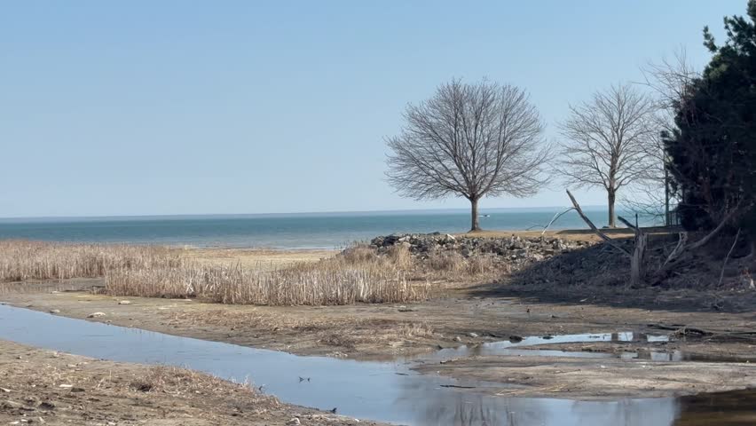 A pan across the Linwood, Michigan beach overlooking Lake Huron, revealing a Land and Water Conservation Fund sign.