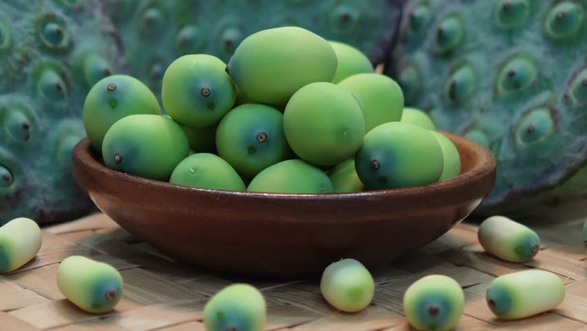 Lotus seeds from the pod on a wooden cup.