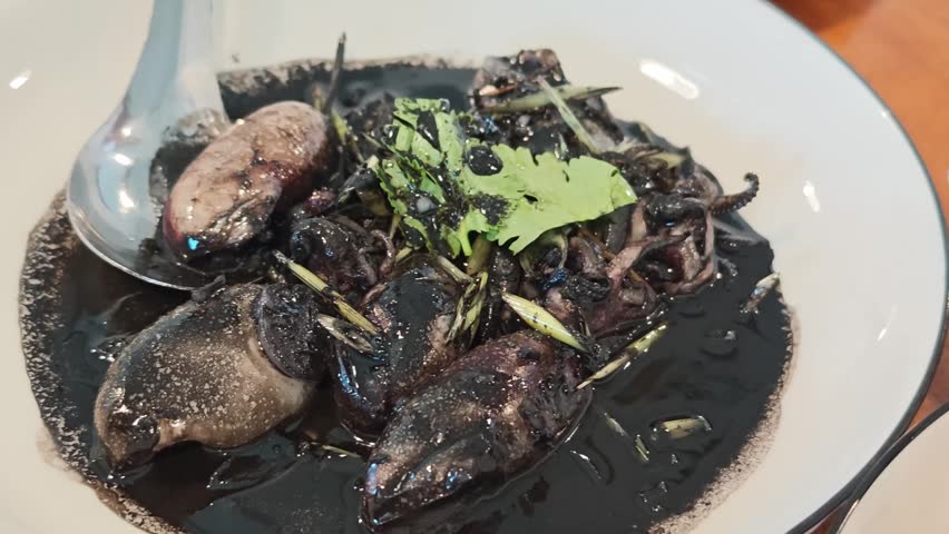 Squid stir-fried in black sauce, a popular Thai dish
