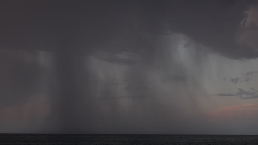 Dramatic Storm Clouds and Rain Shafts Over the Sea Near Tropea