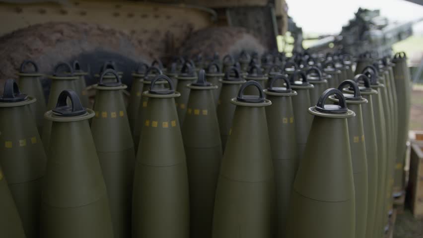 US Army MOS 13B Cannon Crewmember Loading Artillery Ammunition Shells During Field Training