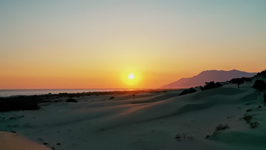 Patara sand dunes sunset aerial view capturing the dramatic golden hour light over the vast desert-like landscape in Antalya, Turkey. Majestic drone shot of coastal dunes.