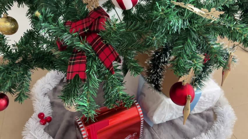 Tilt up of Christmas tree with lights and ornaments