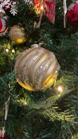 Zoom out from golden ornament on Christmas tree