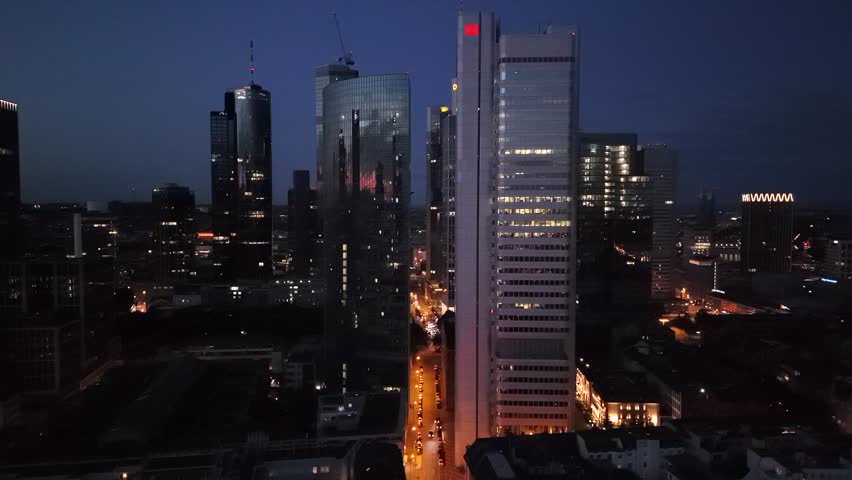 Aerial view of illuminated skyscrapers and city streets in Frankfurt am Main, Hessen, Germany.