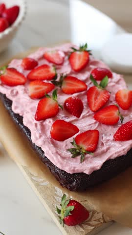 Chocolate sheet cake with strawberry cream cheese frosting with fresh strawberries. 
