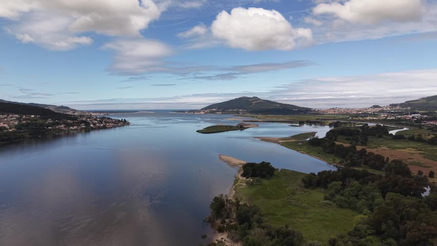 Rio miño river emptying into the atlantic ocean, forming an estuary separating spain and portugal