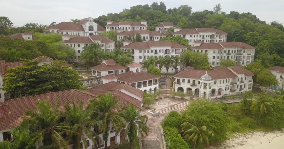 Aerial drone view of luxury resorts building by calm island beach scenery at Pulau Besar, Malaysia