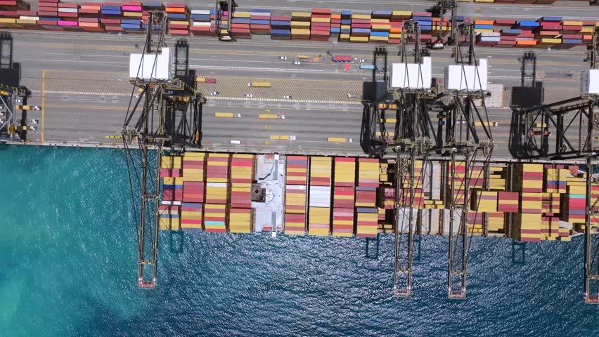 Aerial view of the Caucedo container terminal with colorful shipping containers and large cranes at the port in Boca Chica, Santo Domingo, Dominican Republic.