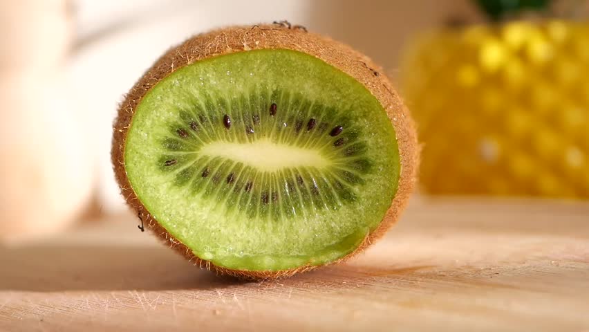 Savor the delight of cutting a fresh, juicy kiwi.