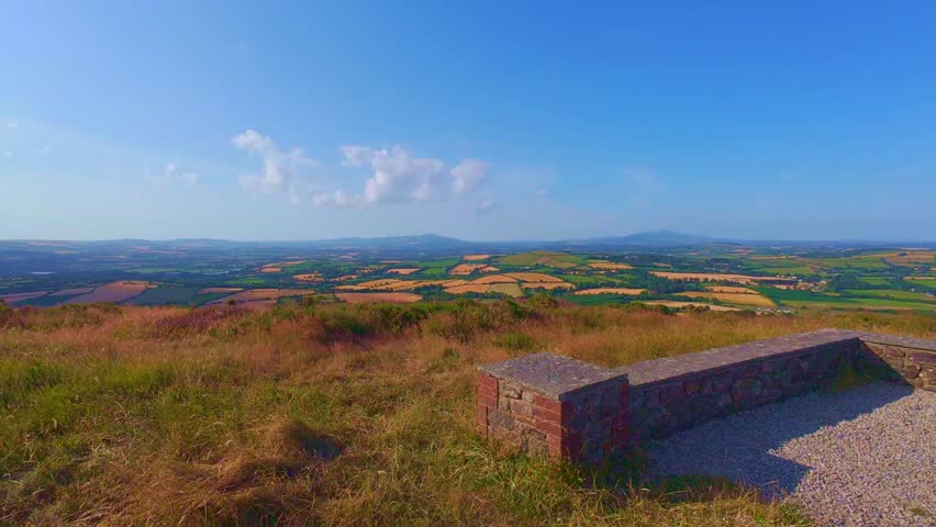 Stone viewpoint bench on top of hill looking over valley