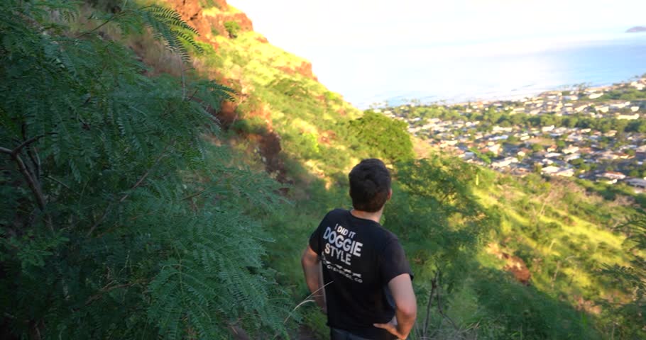 Man looking over Makaha Valley neighborhood on Oahu, Hawaii