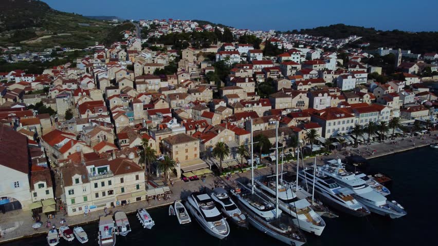 Scenic aerial view of hvar town on hvar island in croatia. Majestic medieval cityscape with luxury yachts moored in the busy harbor