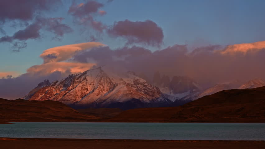 Timelapse of sunrise shot with dramatic alpenglow above Torres del Paine peaks