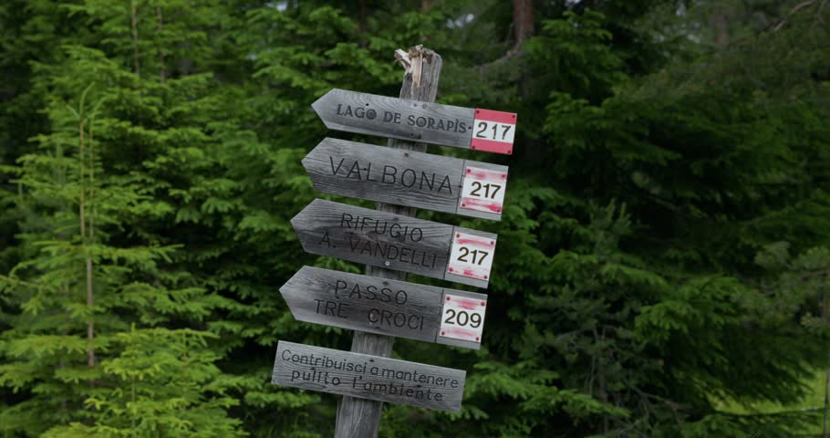 A Wooden Signpost Direction Toward Lago di Sorapis Along A Mountain Trail In The Dolomites of Italy. Static Shot