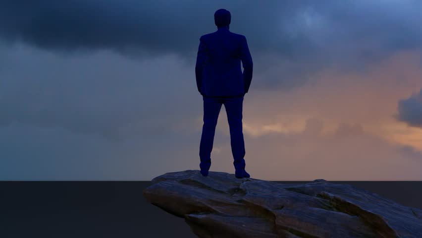 The silhouette of a boss contemplating life atop a mountain peak