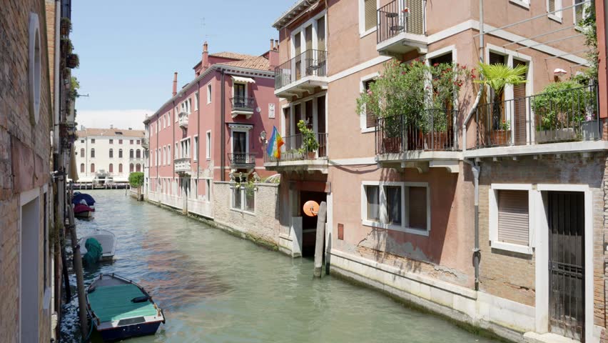 Narrow Venetian Canal Between Historic Buildings in Venice