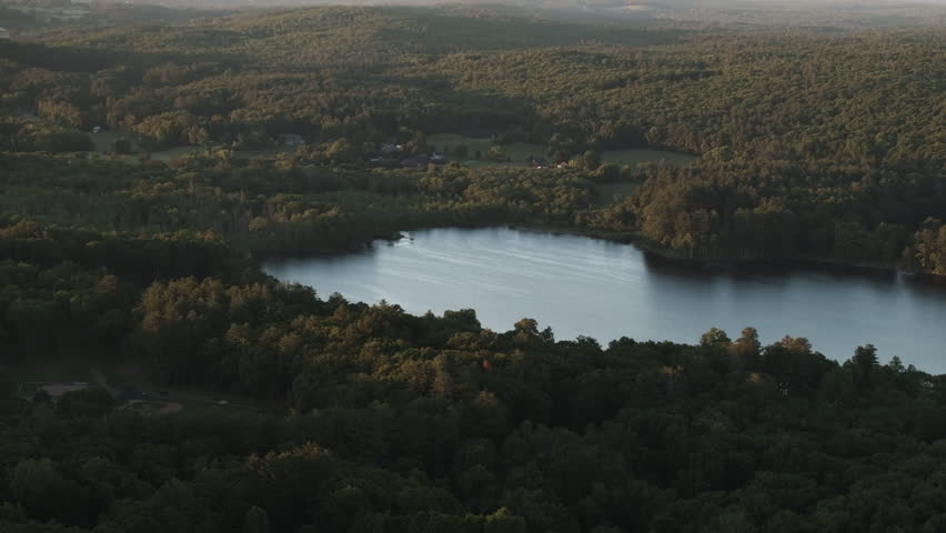 Aerial view of a lake in rural Connecticut. Shot on a summer day at sunset.