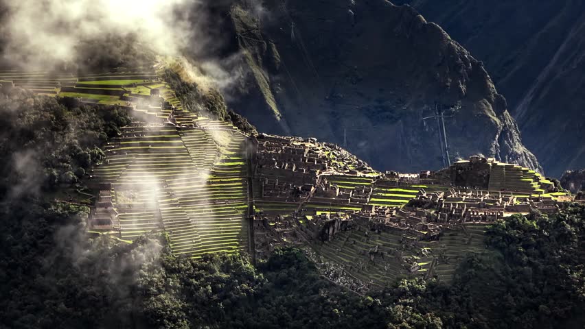 World famous Machu Picchu Inca citadel viewed through mist in Andes. Aerial