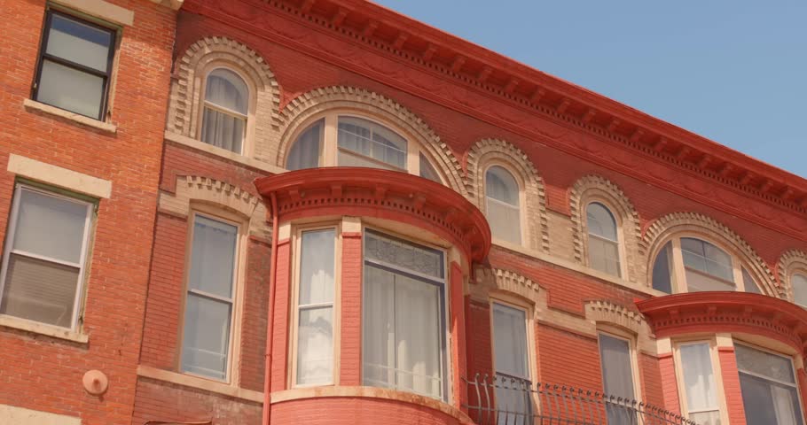 Perspective looking up shot of the traditional and ornate red brick historic building facade featuring arched windows of Galena architecture, Galena, Illinois, USA