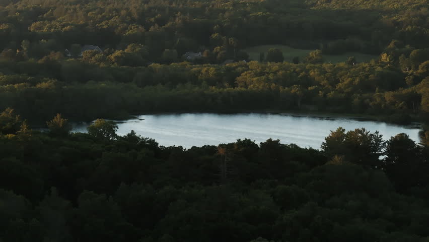 Aerial view of a lake in rural Connecticut. Shot on a summer day at sunset.
