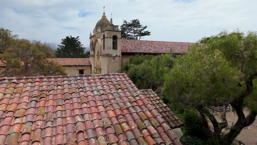 Views show the Mission church in Carmel, California, highlighting rooftops and trees around the area.
